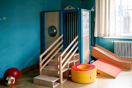 The wooden playhouse with a slide and many other details provides a lot of fun and movement
