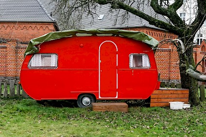 The bright red caravan in the Villa garden is always ready for fun and play