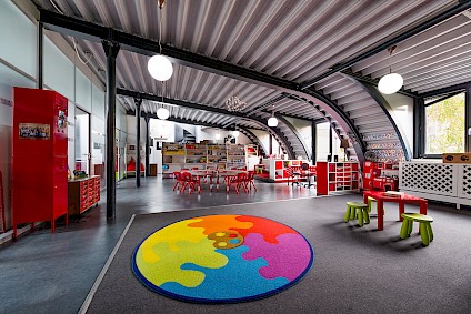 The Picasso group room in the bright, spacious attic with its red accents
