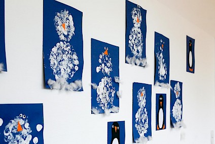 Snowman collages made by the children out of paper, paint and cotton wool