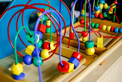 Logic game with many colorful wooden shapes which have to be moved into a target
